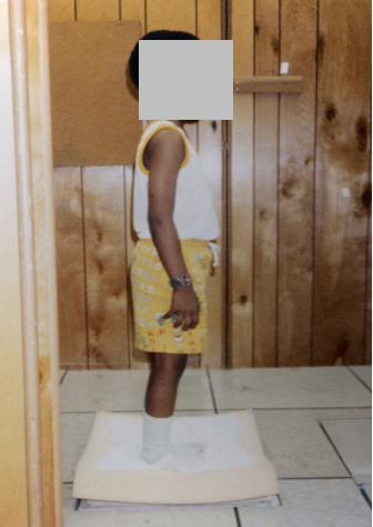 A child standing on a foam pad measuring postural balance
