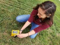 MPH Student, Devin Knutson using XRF equipment to measure lead levels in soil