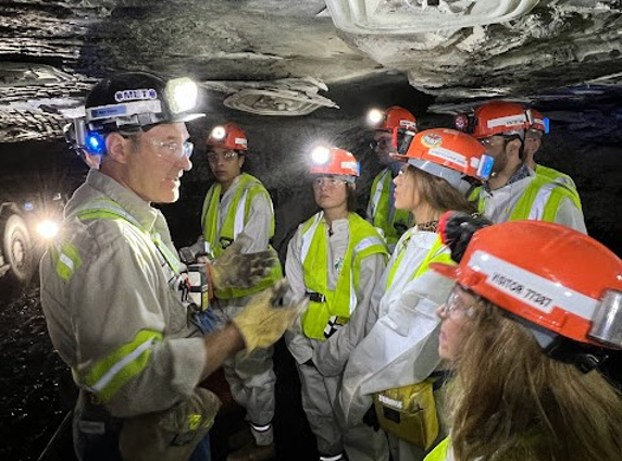 image of students wearing lighted hardhats in a coal mine