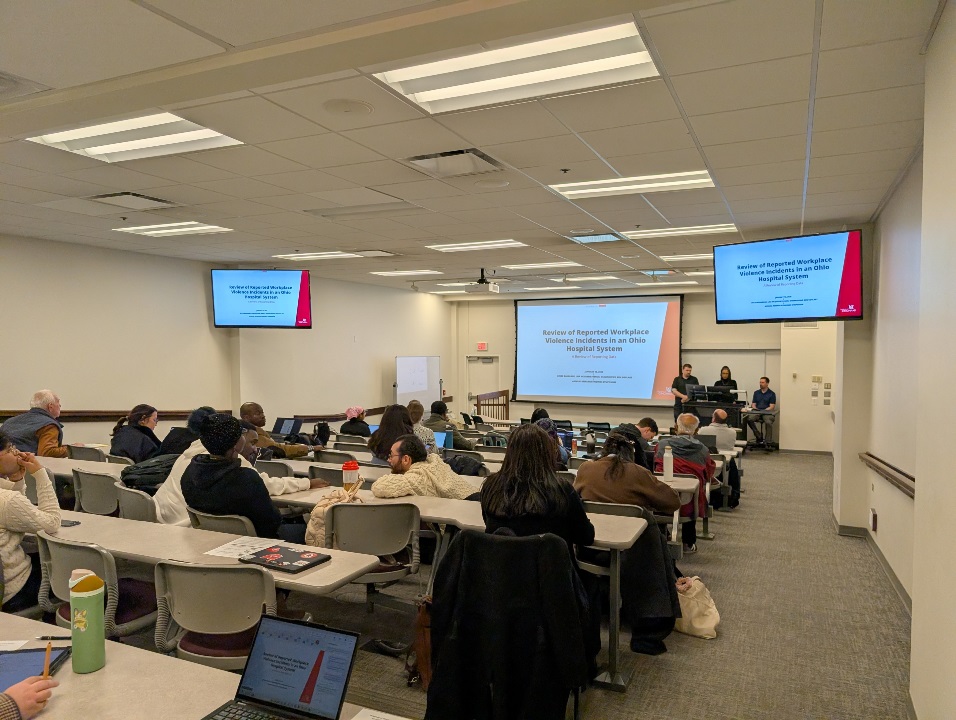 People in an auditorium watching a presentation