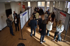 people viewing posters in a conference space