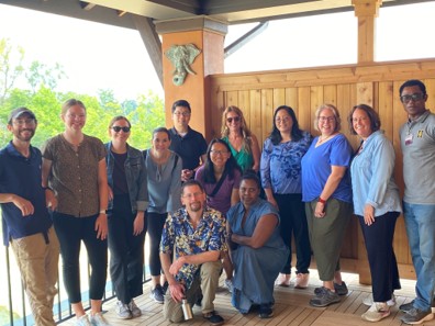 people posing outside on a balcony