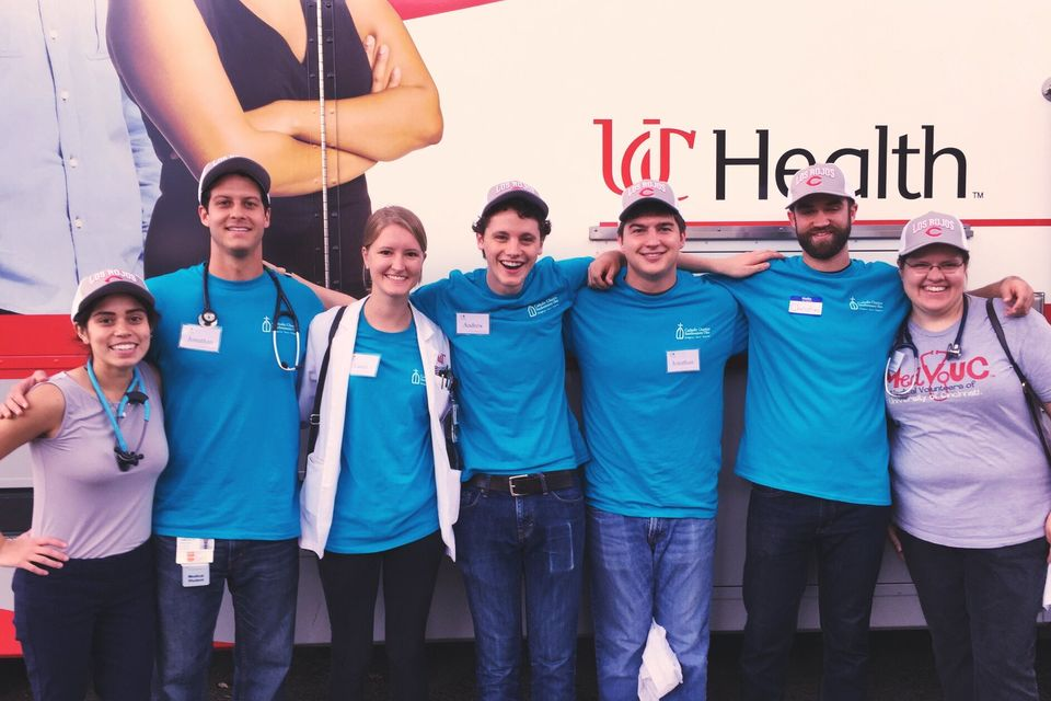 Students in front of UC Health Logo