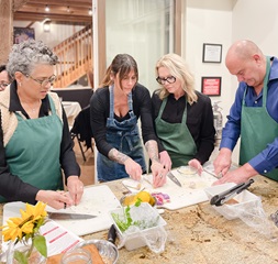 Group of people cooking a healthy meal at the turner farm teaching kitchen