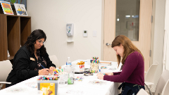 Art therapist and participant participating in art therapy