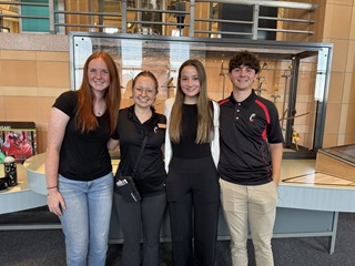 group of four volunteers standing at the cincinnati museum center