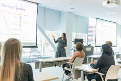 Lady presenting in front of classroom