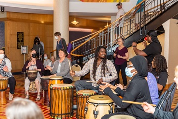 group of people doing a drum circle