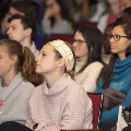 Women watch speaker