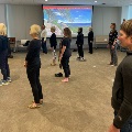 People doing tai chi on brown floor