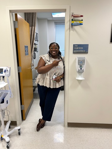 Faculty standing in the doorway pointing