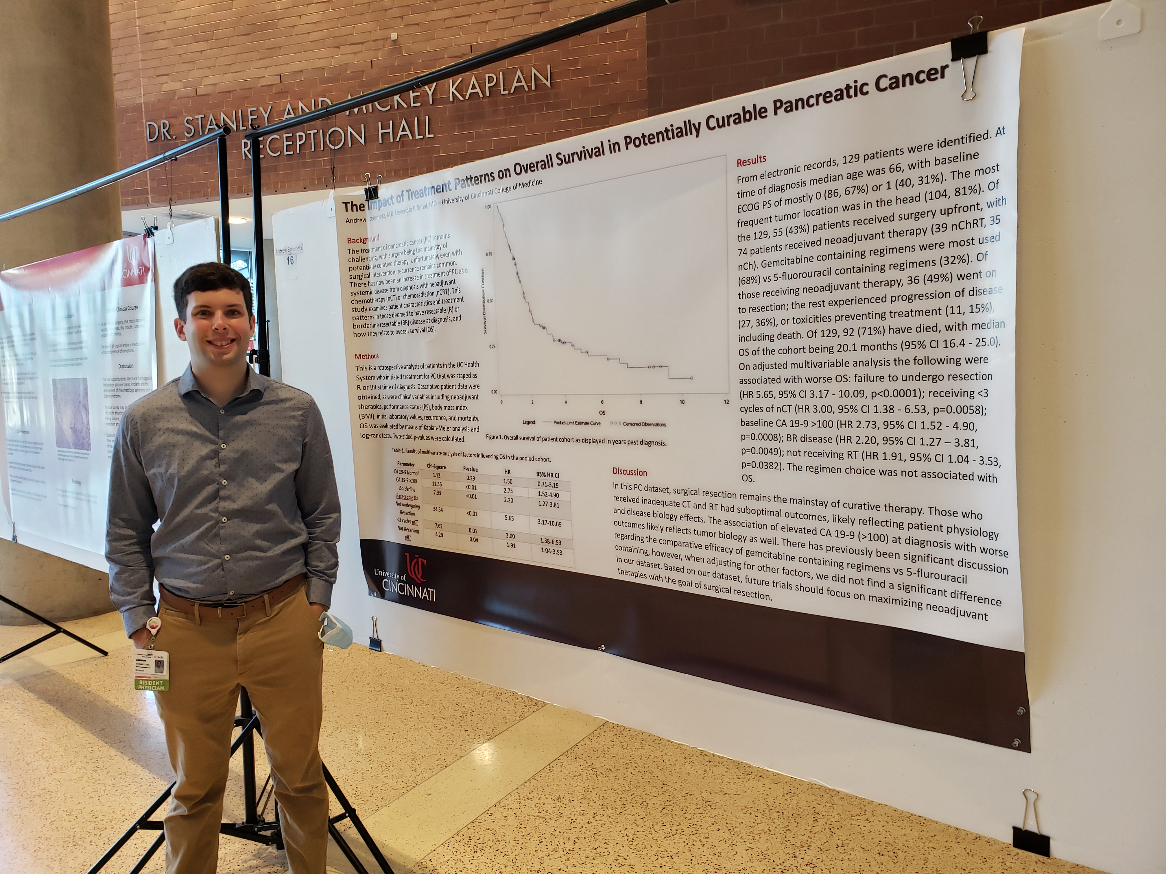 Resident Physician Standing In Front of  Research Poster