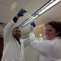 Lab member pouring into funnel