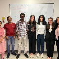 K Lab members standing in front of whiteboard